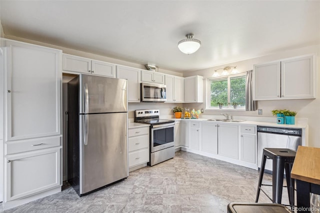 5645 W 5th Ave Unit 5645 & 5655, Lakewood, CO 80226 - kitchen with stainless steel appliances, light countertops, and white cabinets