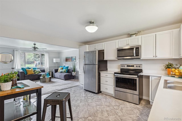 5645 W 5th Ave Unit 5645 & 5655, Lakewood, CO 80226 - kitchen with stainless steel appliances, light countertops, white cabinets, and open floor plan