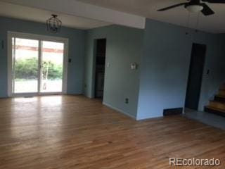 206 Cielo Vista St, Colorado Springs, CO 80911 - unfurnished living room with a ceiling fan, wood finished floors, stairway, and baseboards