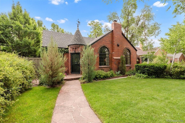 1226 Dexter St, Denver, CO 80220 - tudor-style house with brick siding, roof with shingles, and a chimney