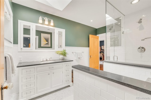 1226 Dexter St, Denver, CO 80220 - bathroom with a shower stall, tile walls, vanity, tile patterned flooring, and wainscoting