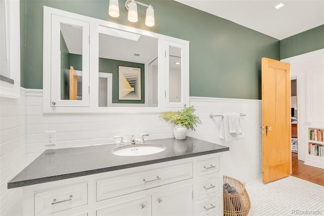 1226 Dexter St, Denver, CO 80220 - bathroom with vanity and a wainscoted wall
