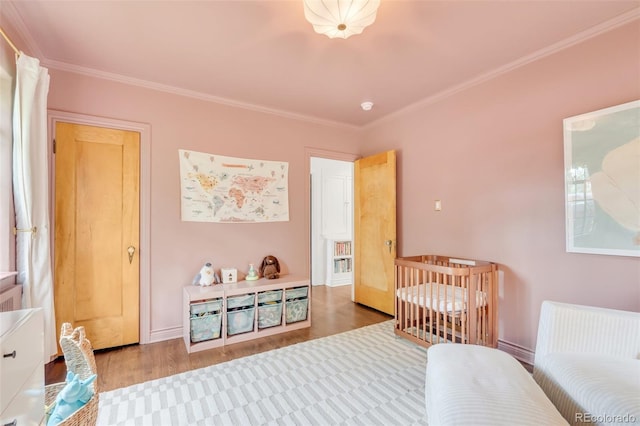 1226 Dexter St, Denver, CO 80220 - bedroom featuring wood finished floors, crown molding, and baseboards