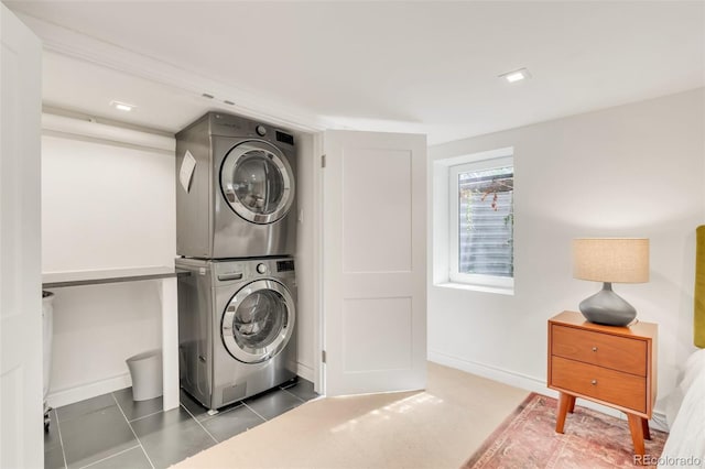 1226 Dexter St, Denver, CO 80220 - laundry room with estacked washer and dryer, baseboards, and tile patterned flooring