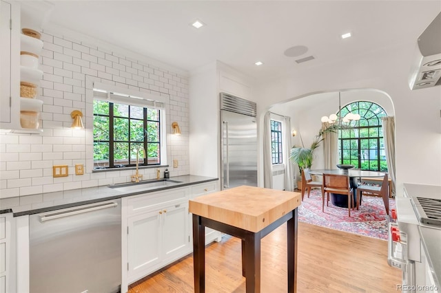 1226 Dexter St, Denver, CO 80220 - kitchen with stainless steel appliances, open shelves, dark countertops, plenty of natural light, and recessed lighting