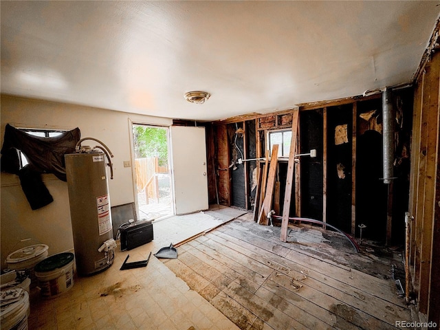 605 E Rio Blanco Ave, Rangely, CO 81648 - misc room with gas water heater and hardwood / wood-style floors