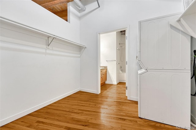 1745 Wazee St Unit 2B, Denver, CO 80202 - spacious closet with light wood-style flooring, a towering ceiling, and beamed ceiling