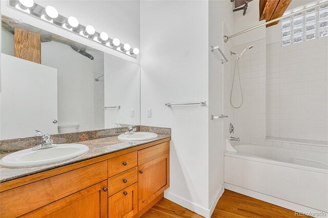 1745 Wazee St Unit 2B, Denver, CO 80202 - bathroom featuring a sink, bathing tub / shower combination, toilet, and wood finished floors