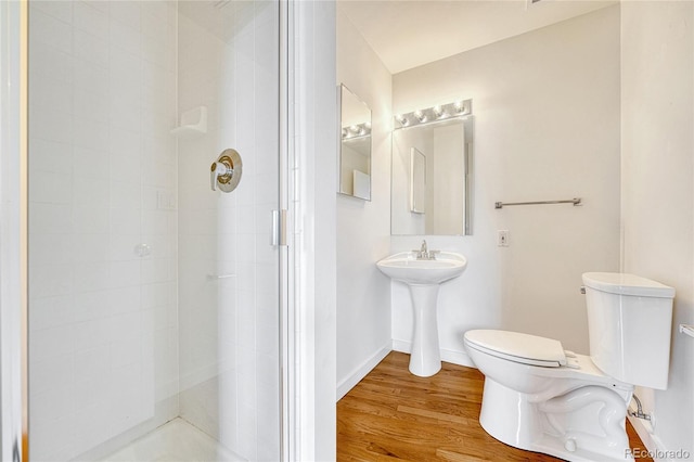 1745 Wazee St Unit 2B, Denver, CO 80202 - bathroom with toilet, baseboards, wood finished floors, and a stall shower