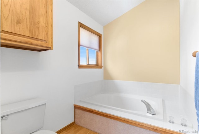 full bath with a garden tub and toilet
