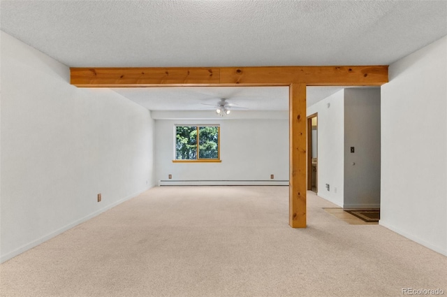 carpeted spare room featuring baseboards, baseboard heating, a textured ceiling, and a ceiling fan