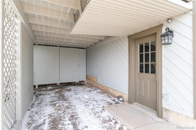property entrance with an attached carport