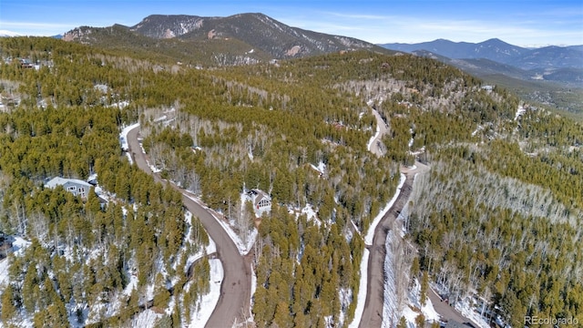 aerial view featuring a view of trees and a mountain view