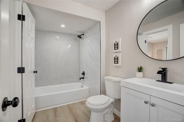 full bath featuring toilet, washtub / shower combination, wood finished floors, and vanity