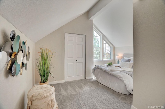 bedroom with carpet floors, baseboards, and lofted ceiling