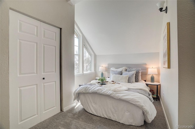 carpeted bedroom featuring vaulted ceiling and baseboards