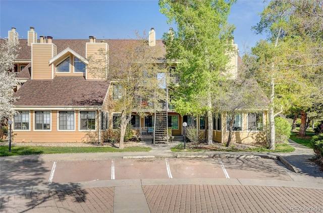 multi unit property featuring uncovered parking and a chimney