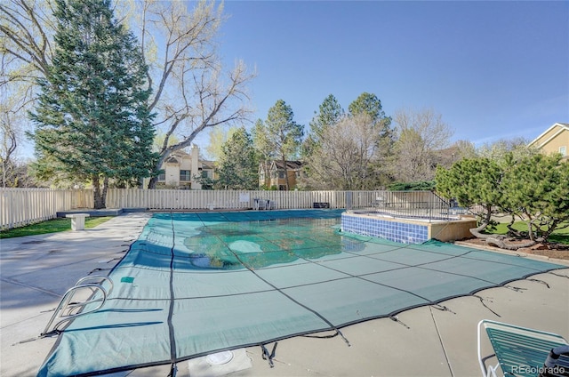 view of swimming pool featuring a fenced backyard, a fenced in pool, and a patio