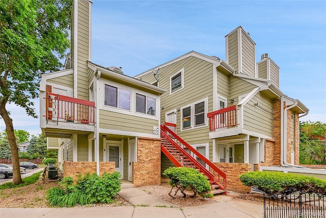 922 S Dearborn Way Unit 8, Aurora, CO 80012 - exterior space with a chimney, brick siding, a balcony, and stairway