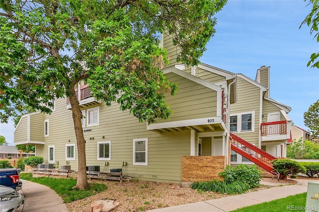 922 S Dearborn Way Unit 8, Aurora, CO 80012 - view of side of property featuring a chimney, stairway, and central air condition unit