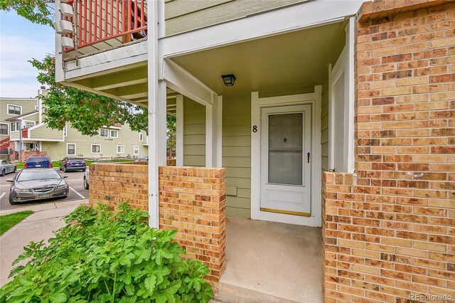 922 S Dearborn Way Unit 8, Aurora, CO 80012 - property entrance with covered porch and brick siding
