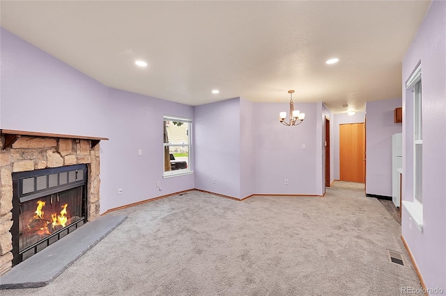 922 S Dearborn Way Unit 8, Aurora, CO 80012 - unfurnished living room featuring a fireplace, a chandelier, light colored carpet, baseboards, and recessed lighting
