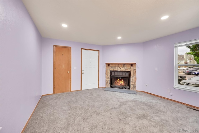 922 S Dearborn Way Unit 8, Aurora, CO 80012 - unfurnished living room featuring a stone fireplace, carpet floors, recessed lighting, and baseboards