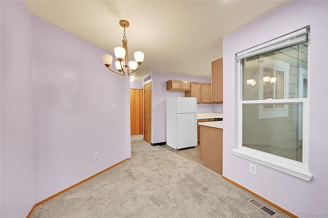 922 S Dearborn Way Unit 8, Aurora, CO 80012 - unfurnished dining area with a chandelier, baseboards, and light colored carpet
