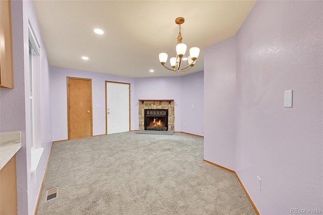 922 S Dearborn Way Unit 8, Aurora, CO 80012 - unfurnished living room with carpet, a chandelier, baseboards, recessed lighting, and a stone fireplace