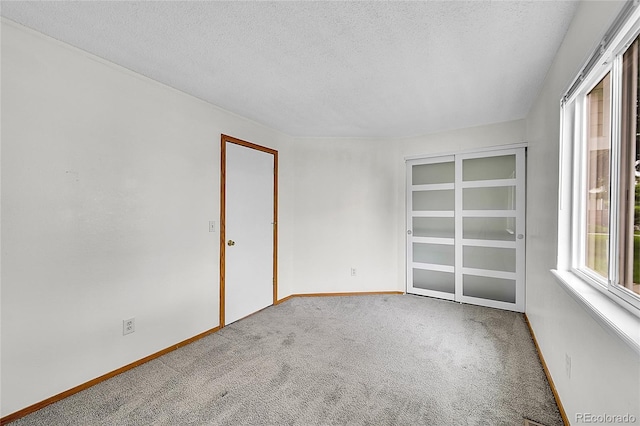 922 S Dearborn Way Unit 8, Aurora, CO 80012 - carpeted spare room with a textured ceiling and baseboards