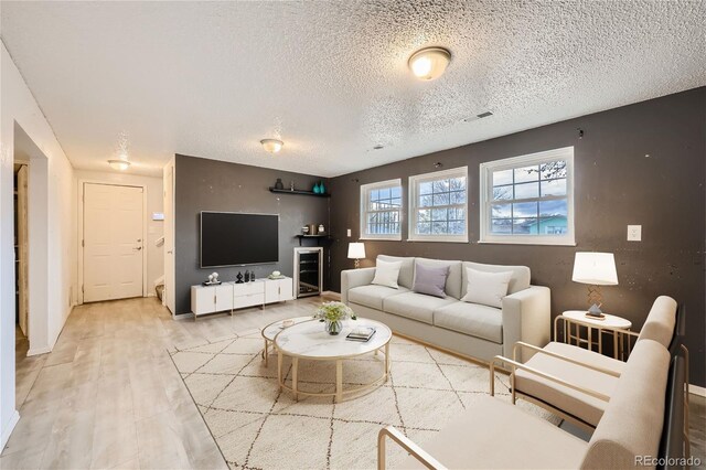 living room with hardwood / wood-style floors and a textured ceiling