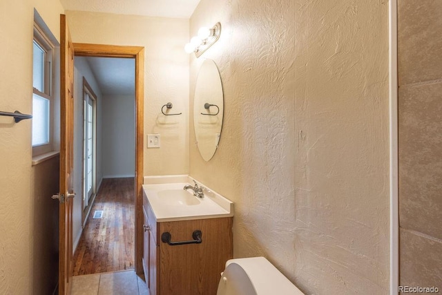 bathroom featuring toilet, tile patterned floors, and vanity