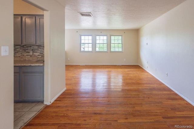 empty room featuring light hardwood / wood-style floors and a textured ceiling