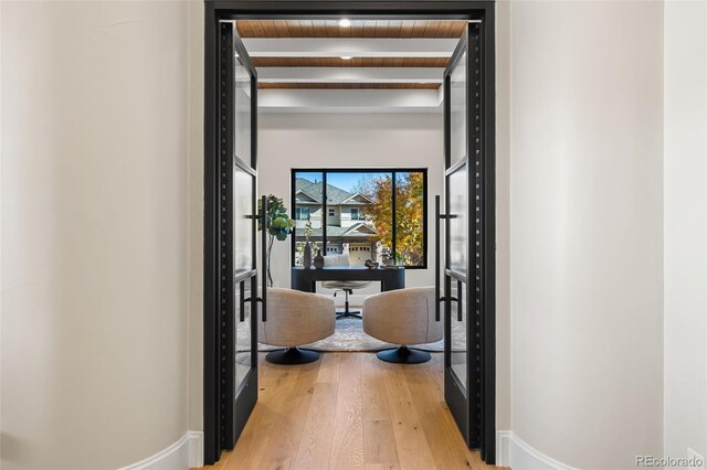 hall with hardwood / wood-style floors, beamed ceiling, and wooden ceiling