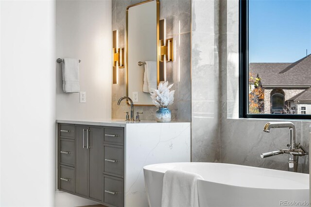 bathroom with a bath and vanity