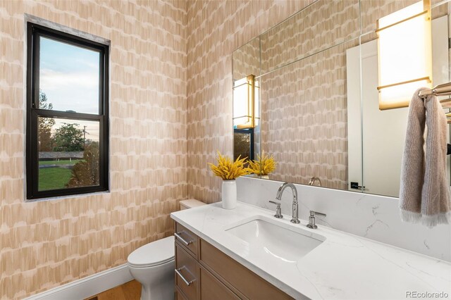 bathroom featuring vanity and toilet