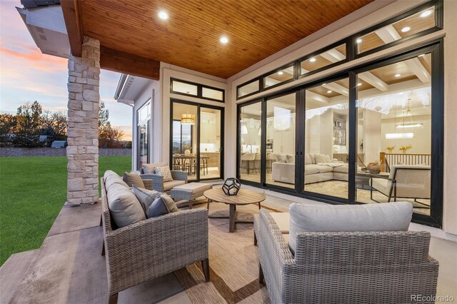 patio terrace at dusk featuring an outdoor living space