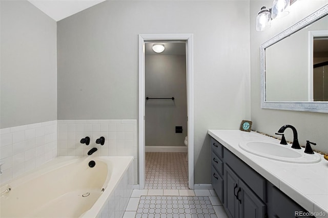 11245 San Joaquin Rdg, Littleton, CO 80127 - full bath with vanity, tile patterned flooring, toilet, a bath, and baseboards