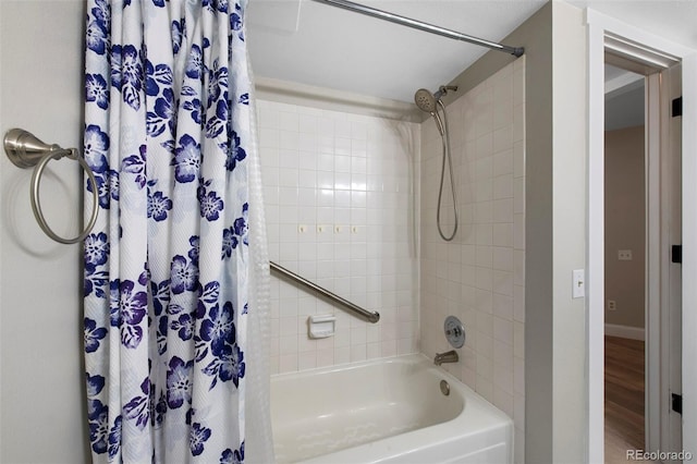 11245 San Joaquin Rdg, Littleton, CO 80127 - bathroom featuring shower / tub combo, wood finished floors, and baseboards