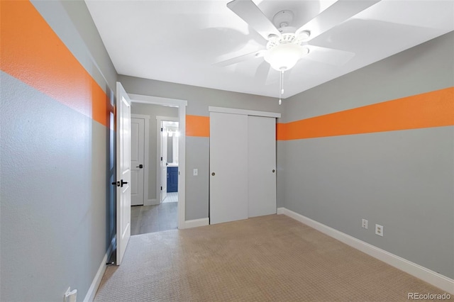 11245 San Joaquin Rdg, Littleton, CO 80127 - unfurnished bedroom featuring light colored carpet, a closet, baseboards, and a ceiling fan