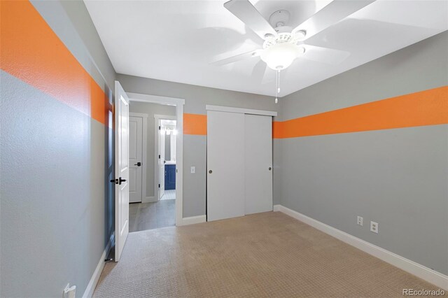 11245 San Joaquin Rdg, Littleton, CO 80127 - unfurnished bedroom featuring light colored carpet, a closet, baseboards, and a ceiling fan