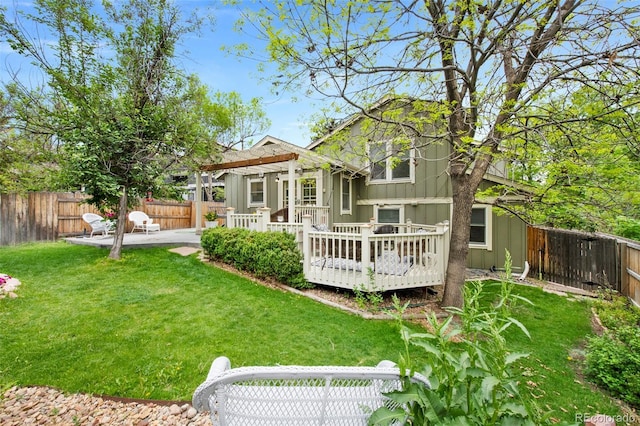 11245 San Joaquin Rdg, Littleton, CO 80127 - back of property with board and batten siding, a wooden deck, and a patio