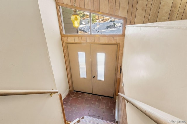 entryway featuring wooden walls