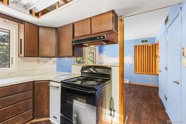 kitchen with baseboard heating, decorative backsplash, electric range, and dark hardwood / wood-style flooring