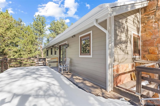 view of property exterior with a wooden deck