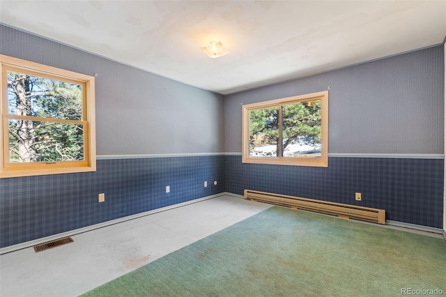 empty room featuring concrete flooring and a baseboard radiator