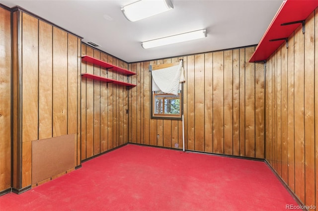 empty room with wooden walls and carpet floors