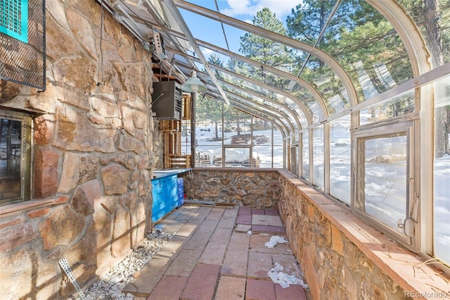 unfurnished sunroom with vaulted ceiling