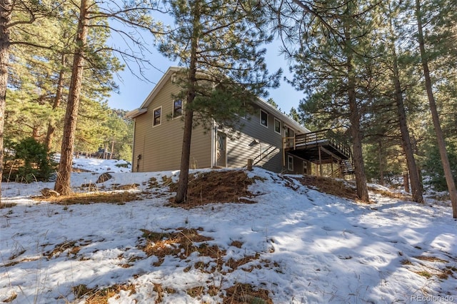 view of snow covered exterior featuring a deck