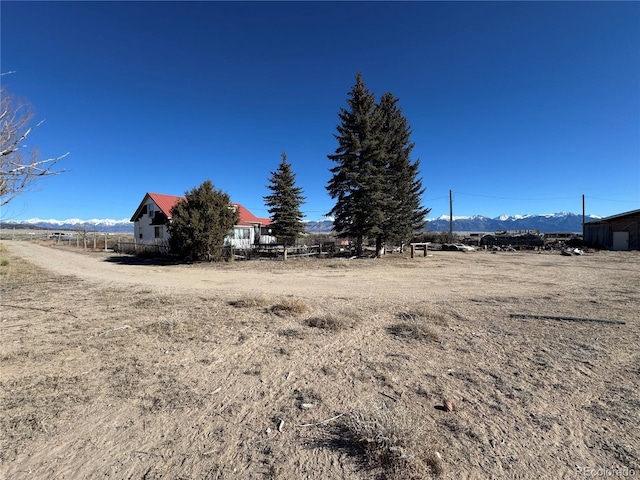 view of yard with a mountain view and a rural view